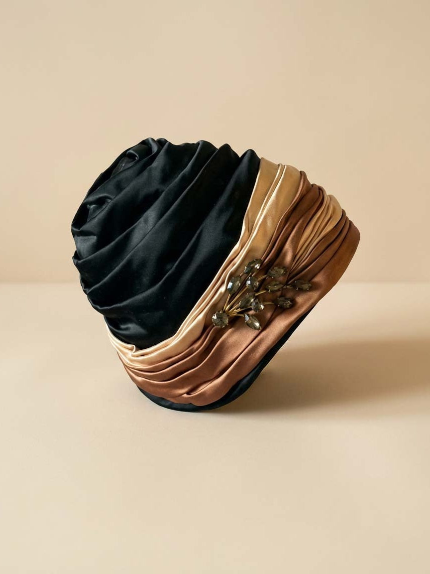 Vintage 1960s Ferncroft Satin Turban Hat – Black, Champagne & Bronze Draped Cloche Hat with Rhinestone Brooch